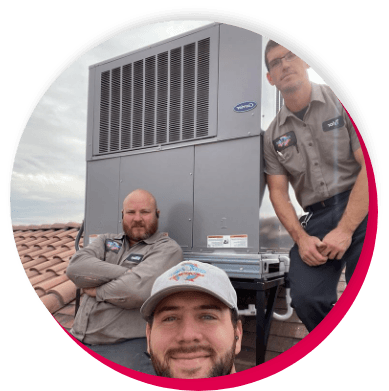 workers on top of roof by an HVAC unit