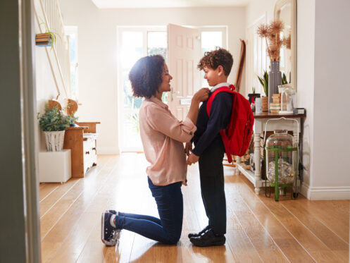 A mom getting her son ready for the first day at school